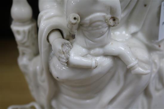 A large Chinese blanc de chine group of Guanyin and child, Kangxi period, damage and losses